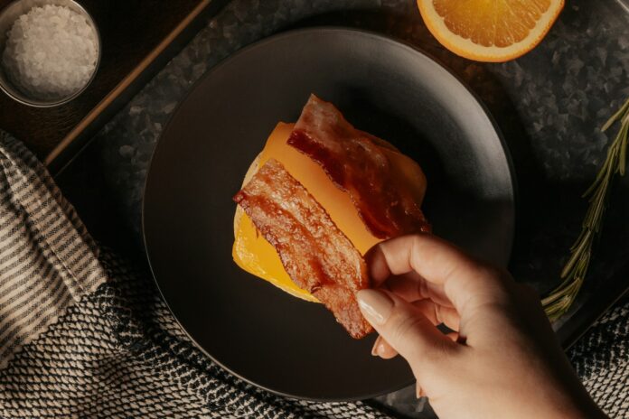 Photo by Wright Brand Bacon person holding a bread with sliced lemon