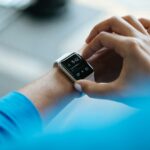“웨어러블 데이터가 주도하는 건강관리 혁명: 손목에서 시작되는 일상 속 건강 비결” person clicking Apple Watch smartwatch